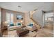 Cozy living room featuring comfortable seating, a decorative rug, and staircase access at 165 Calm Morning Ave, Henderson, NV 89002