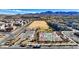 An aerial view of neighborhood basketball courts and a sandlot with homes and mountains in background at 2120 Waterlily View St, Henderson, NV 89044