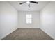Bright bedroom with plush carpet, ceiling fan, recessed lighting, and a window with stylish white shutters at 2120 Waterlily View St, Henderson, NV 89044