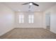 Bright bedroom with plush carpet, ceiling fan, recessed lighting, and two windows with stylish white shutters at 2120 Waterlily View St, Henderson, NV 89044