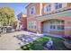 Inviting townhome featuring a decorative lawn with shade trees and pavers at 2120 Waterlily View St, Henderson, NV 89044