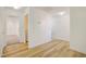 Hallway with hard surface floors leading to bedrooms and laundry room at 2120 Waterlily View St, Henderson, NV 89044