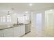 Open kitchen with stainless steel dishwasher and sink with view of living area at 2120 Waterlily View St, Henderson, NV 89044