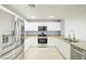 Updated kitchen with stainless steel appliances, granite countertops, and white cabinetry at 2120 Waterlily View St, Henderson, NV 89044