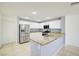 Bright kitchen features stainless steel appliances, granite countertops and tile floors at 2120 Waterlily View St, Henderson, NV 89044