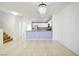 Bright open-concept living space with tile flooring, stairs, and easy access to kitchen at 2120 Waterlily View St, Henderson, NV 89044