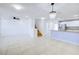Bright open-concept living space with tile flooring, chandelier, and easy access to kitchen at 2120 Waterlily View St, Henderson, NV 89044