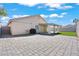 Backyard view features a patio, artificial grass, block wall, and mature landscaping at 2419 Country Orchard St, North Las Vegas, NV 89030