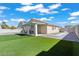 Backyard with artificial grass, patio area with swing, and block wall at 2419 Country Orchard St, North Las Vegas, NV 89030