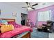 Vibrant bedroom showcasing a pink theme, a comfortable bed, and playful decor at 2419 Country Orchard St, North Las Vegas, NV 89030