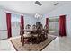 Elegant dining room featuring a stylish chandelier, large windows, and a beautiful dark wood table with seating for six at 2419 Country Orchard St, North Las Vegas, NV 89030