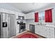 Modern kitchen featuring stainless steel appliances, white cabinets, and marble floors at 2419 Country Orchard St, North Las Vegas, NV 89030