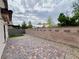The spacious backyard features a stone perimeter, artificial turf, and privacy, great for outdoor enjoyment at 4117 Midnight Crest Ave, North Las Vegas, NV 89031
