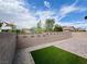 The spacious backyard features a stone perimeter, artificial turf, and privacy, great for outdoor enjoyment at 4117 Midnight Crest Ave, North Las Vegas, NV 89031