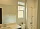 Clean bathroom features tub-shower combo and vanity sink with a large mirror at 4117 Midnight Crest Ave, North Las Vegas, NV 89031
