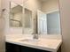 Bright bathroom features a white quartz countertop, framed mirrors, and brushed nickel fixtures at 4117 Midnight Crest Ave, North Las Vegas, NV 89031