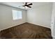 Cozy bedroom featuring a ceiling fan, neutral carpet, and a bright window at 4117 Midnight Crest Ave, North Las Vegas, NV 89031