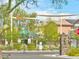A community playground with shade sails, green equipment, and manicured landscaping behind a gated entrance at 4117 Midnight Crest Ave, North Las Vegas, NV 89031