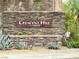 Elegant stone entrance sign for Crescent Hill by Lennar surrounded by desert landscaping at 4117 Midnight Crest Ave, North Las Vegas, NV 89031