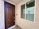 A brown front door with a keypad lock and a window to the side of the door at 4117 Midnight Crest Ave, North Las Vegas, NV 89031