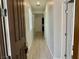 A narrow hallway with neutral-toned walls and floor tiles at 4117 Midnight Crest Ave, North Las Vegas, NV 89031