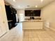 Modern kitchen equipped with black appliances, granite countertops, and a convenient center island at 4117 Midnight Crest Ave, North Las Vegas, NV 89031