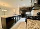 Well-equipped kitchen with a granite countertop island, black appliances, and modern fixtures at 4117 Midnight Crest Ave, North Las Vegas, NV 89031