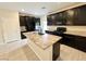 Kitchen island featuring granite countertops, undermount sink, and black cabinets at 4117 Midnight Crest Ave, North Las Vegas, NV 89031