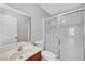 Updated bathroom features a glass-enclosed shower and wood vanity at 5576 W Rochelle Ave # 9C, Las Vegas, NV 89103