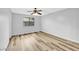 Bright bedroom featuring wood-look floors, neutral walls, a ceiling fan, and a window at 5576 W Rochelle Ave # 9C, Las Vegas, NV 89103