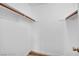 Walk-in closet with white walls, wood trim, and simple shelving for organized storage at 5576 W Rochelle Ave # 9C, Las Vegas, NV 89103