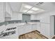 Bright kitchen features white cabinets, countertops, and appliances at 5576 W Rochelle Ave # 9C, Las Vegas, NV 89103