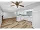 Open kitchen with white cabinets, appliances, and a ceiling fan at 5576 W Rochelle Ave # 9C, Las Vegas, NV 89103