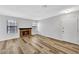 Bright living room featuring wood-look floors, a fireplace, and natural light at 5576 W Rochelle Ave # 9C, Las Vegas, NV 89103
