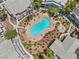 Aerial view of the community pool, surrounded by lush landscaping and lounge chairs at 5710 E Tropicana Ave # 1184, Las Vegas, NV 89122