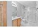 Bathroom featuring wood cabinets, a shower with glass doors, and well-lit vanity at 5710 E Tropicana Ave # 1184, Las Vegas, NV 89122
