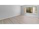 Bedroom with wood-look floors and natural light streaming through the window at 5710 E Tropicana Ave # 1184, Las Vegas, NV 89122
