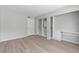 Bright bedroom featuring modern wood floors, a closet, and a built-in desk area for added convenience at 5710 E Tropicana Ave # 1184, Las Vegas, NV 89122