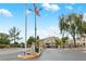 Community entrance with lush greenery and a gate offering privacy and security at 5710 E Tropicana Ave # 1184, Las Vegas, NV 89122
