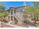 Two-story condo building with a private balcony, desert landscaping, and a beige stucco exterior at 5710 E Tropicana Ave # 1184, Las Vegas, NV 89122