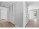Hallway featuring wood-look floors, bi-fold doors, and neutral wall paint at 5710 E Tropicana Ave # 1184, Las Vegas, NV 89122