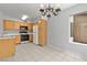 Kitchen with wood cabinets, tile flooring, and modern appliances at 5710 E Tropicana Ave # 1184, Las Vegas, NV 89122