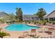 Inviting community pool surrounded by lounge chairs, perfect for relaxation and recreation at 5710 E Tropicana Ave # 1184, Las Vegas, NV 89122