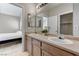 Bathroom featuring double sinks, a decorative plant, and an adjacent bedroom at 6057 Leaping Foal St, North Las Vegas, NV 89081