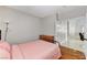 Cozy bedroom featuring wood floors, comfortable bed, dresser, and abundant natural light at 6057 Leaping Foal St, North Las Vegas, NV 89081