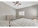 Neutral bedroom with a ceiling fan, shuttered window, and tiled floor at 6057 Leaping Foal St, North Las Vegas, NV 89081