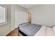 Cozy bedroom with a wood floor, sliding closet doors, and natural light at 6057 Leaping Foal St, North Las Vegas, NV 89081