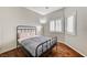 Bedroom with hardwood floors, black metal bed frame, and plantation shutters on the windows at 6057 Leaping Foal St, North Las Vegas, NV 89081