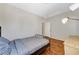 A cozy bedroom with a wooden floor and simple decor with a nice lamp at 6057 Leaping Foal St, North Las Vegas, NV 89081