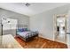 Bedroom with wood floors, window with shutters, and doorway that leads to the living area at 6057 Leaping Foal St, North Las Vegas, NV 89081
